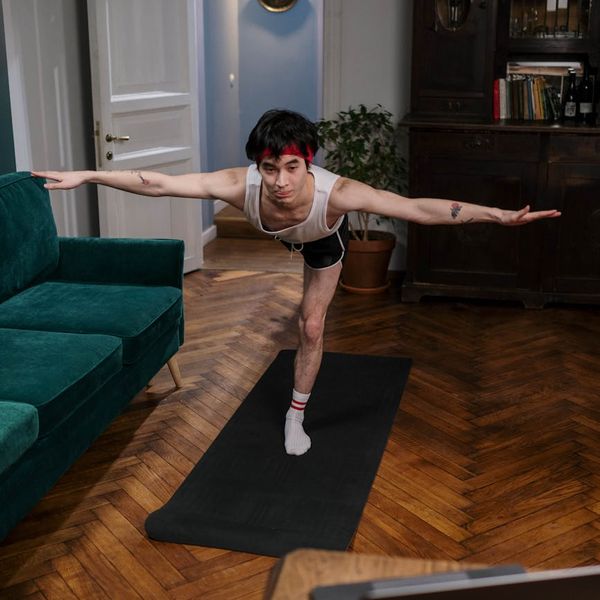 Person holding a challenging yoga pose demonstrating strength and balance.